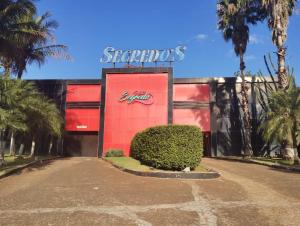 a red building with a starbucks sign on it at Segredos in Araras