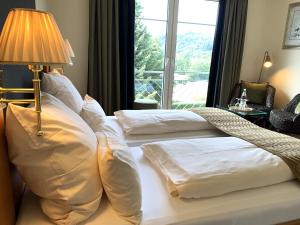 two beds in a hotel room with a window at Das Landhaus ***S in Prüm