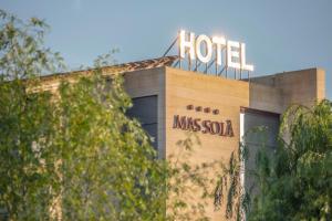 a hotel sign on the top of a building at Hotel Mas Solà in Santa Coloma de Farners