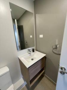 a bathroom with a sink and a mirror at Departamento a orillas del lago in Llanquihue
