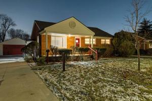 a house with snow on the ground in front of it at Elegant Oasis 4 Bedroom Home Away from Home in Utica