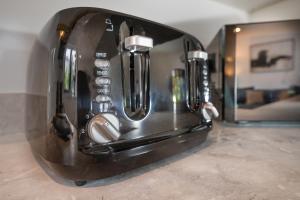 a black toaster sitting on a counter in a kitchen at Luxury 4 Beds 2 Bath Near City Centre Freeparking in Southampton