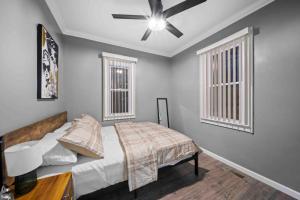 a bedroom with a bed and a ceiling fan at Cozy 3bd home in downRoyal Oak in Royal Oak