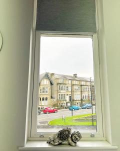 a window with a view of a large building at Town Centre Apartment Harrogate in Harrogate