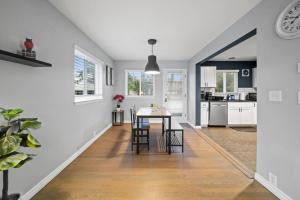 a kitchen and dining room with white walls and a table at Birmingham Urban Retreat 2BR Cozy Haven in Birmingham
