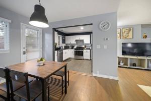 a kitchen and dining room with a table and a clock at Birmingham Urban Retreat 2BR Cozy Haven in Birmingham