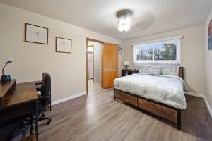 a bedroom with a bed and a desk and a desk at Modern Cozy 1 Bedroom Apartment in Shelby Township in Shelby