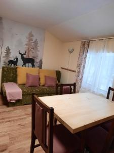 a living room with a couch and a table at Villa Sveti Dimitar in Borovets