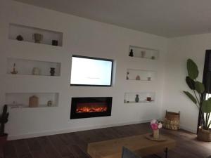 uma sala de estar com lareira e televisão em Villa pampa em Malves