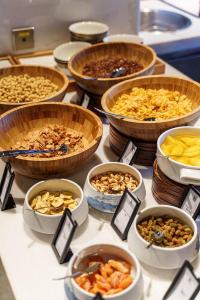 a table topped with bowls of different types of food at Hilton Shanghai Songjiang Guangfulin in Songjiang
