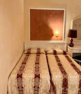 Postel nebo postele na pokoji v ubytování Hotel Erdarelli
