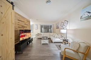 a living room with a couch and a tv at Modern Cozy 1 Bedroom Apartment in Shelby Township in Shelby