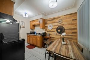 a kitchen with a table and a refrigerator at Modern Cozy 1 Bedroom Apartment in Shelby Township in Shelby