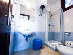 a bathroom with a sink and a toilet and a shower at Residence Hotel La Pelosetta in Stintino