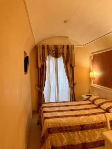 Postel nebo postele na pokoji v ubytování Hotel Erdarelli
