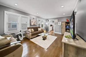 a living room with a couch and a table at Stylish Luxury 3bd home in Downtown Birmingham in Birmingham