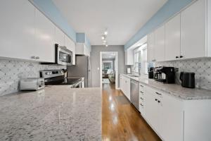 a kitchen with white cabinets and a counter top at Stylish Luxury 3bd home in Downtown Birmingham in Birmingham