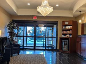 a lobby with a waiting room with a large glass door at Tapa Hotel, Inn & Suites in Mahwah
