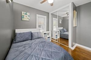 a bedroom with a large bed and a mirror at Stylish Luxury 3bd home in Downtown Birmingham in Birmingham