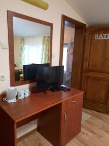 a desk with a television and a mirror in a room at Villa Sveti Dimitar in Borovets