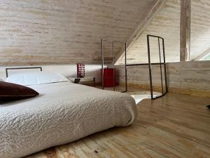 a bedroom with a large bed in a attic at Eco-Chic Retreat: Countryside Oasis Near Florence in Pozzolatico +34 photos