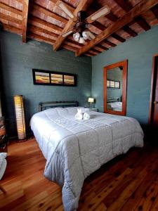 a bedroom with a large bed with a ceiling at Posada San Gabriel in Colonia del Sacramento