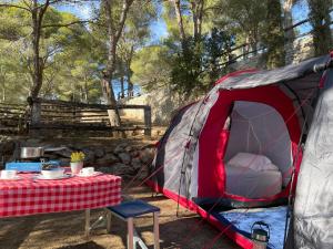 a tent with a table in front of it at Càmping Castell Montgrí **** in L'Estartit