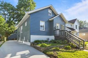 a blue and white house with a driveway at Stylish Luxury 3bd home in Down Town Royal Oak in Royal Oak