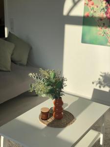 a vase with flowers on a table in a room at Premium Apartment 3 in Dillingen an der Saar