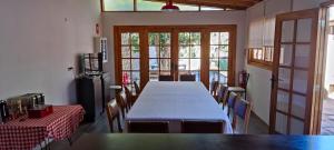 een grote kamer met een lange tafel en stoelen bij Scorpius Hostel in Vicuña