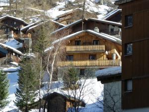 a log cabin in the snow with trees and buildings at CHALET ALISTELLE - 10 à 12 personnes - TIGNES LES BREVIERES in Tignes