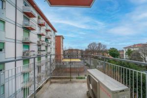 a balcony with a bench in front of a building at Marino's Apartment in Udine