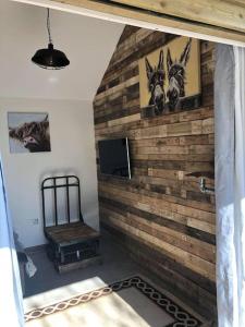 a room with a wooden wall with pictures of animals at Fairway Lodge in Saint Erth