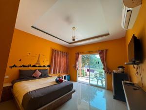 a bedroom with a bed and a large window at Crypto Resort - Koh Larn in Ko Larn