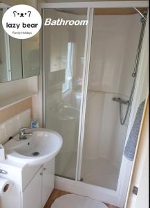 a bathroom with a shower and a sink at Charming 3-Bed Holiday Home in Poole Rockley Park in Poole