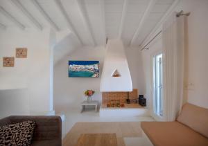 a living room with a couch and a fireplace at Villa Lucia kalafati area in Kalafatis