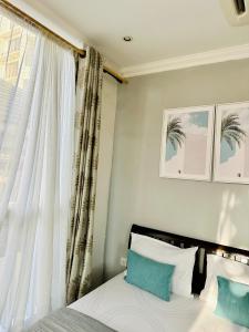 a bedroom with a bed and a window at Ocean Oasis 2Br Condo in Dar es Salaam