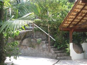 a stone stairway with a stone wall and a building at Studio Formana in Florianópolis +37 photos