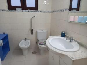 a bathroom with a sink and a toilet at Casa d'Avó in Araújo +18 photos