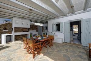 a kitchen and dining room with a table and chairs at Villa Lucia kalafati area in Kalafatis