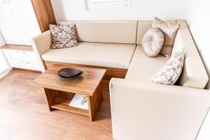 a living room with a couch and a table at FLOATING SEA HOUSE AURORA in Portorož