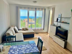 a living room with a couch and a television at SOLITA Apartment with Panoramic View in Byala