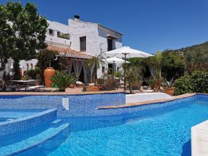 a swimming pool in front of a house at Apartamento Montes by Finca Los Arcos in Comares