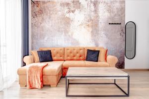 a living room with a couch and a coffee table at Apartamenty Sea Colors - Basen i Sauna! Blisko Plaży - Bardzo Wysoki Standard in Jastrzębia Góra