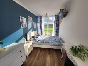 a small bedroom with a bed and a window at Domek na Pagórku in Lwówek Śląski +57 photos