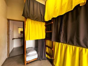 a bedroom with two bunk beds and a mirror at OXE hostel in Moreré