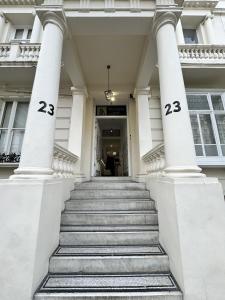 two numbers on the columns of a building with stairs at The Chapter - Hyde Park Hotel in London