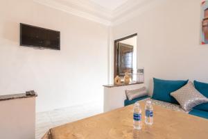 uma sala de estar com duas garrafas de água numa mesa em Appart Atlas em Marraquexe