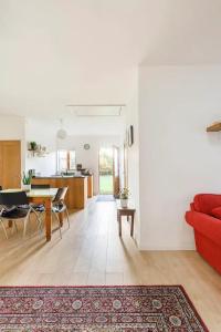 a living room with a red couch and a table at One bedroom spacious apartment in Galway