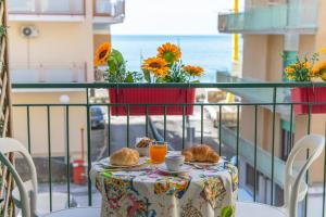 una mesa con pan y zumo de naranja en el balcón en La Casa di Aurora, en Maiori